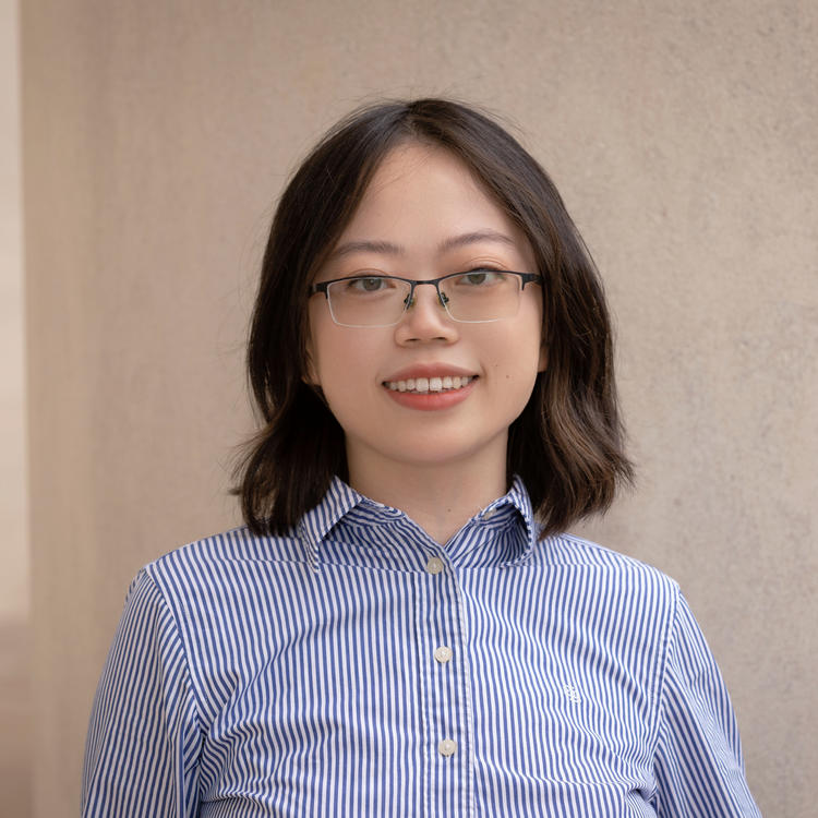 Xin Huang in a blue shirt
